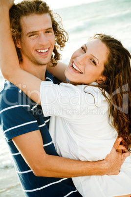 Couple at the beach smiling