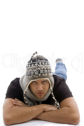 young male lying and wearing woolen cap