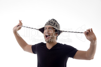 young man playing with his cap