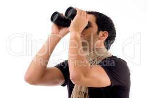 side pose of man looking through binocular
