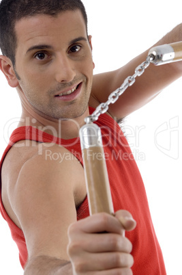 smiling male showing nunchaku