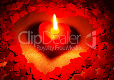 Burning heart shaped candle