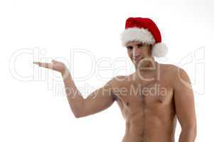 young guy posing in christmas hat with hand gesture