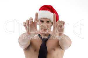male wearing christmas hat and making frame with fingers