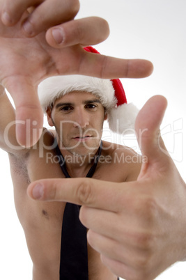 male model wearing christmas hat and framing with hand gesture