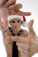 male model wearing christmas hat and framing with hand gesture