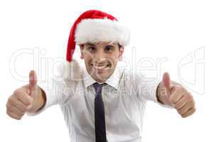 young man wearing christmas hat and showing thumbs up