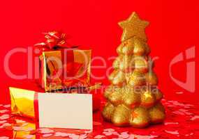 Two presents, blank card and golden evergreen tree