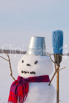 Lonely snowman at a snowy field