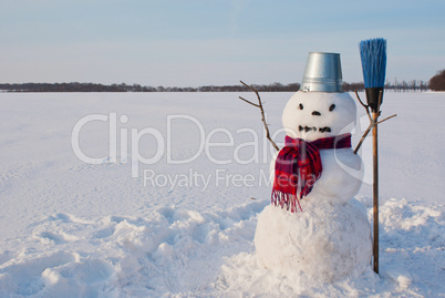 Lonely snowman at a snowy field