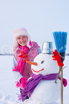 Teenage girl with snowman