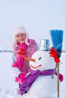 Teenage girl with snowman