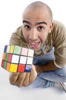 young guy showing his puzzle cube