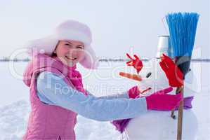Teenage girl with snowman