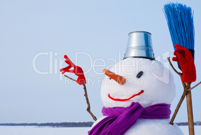 Lonely snowman at a snowy field