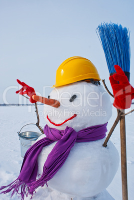 Lonely snowman at a snowy field