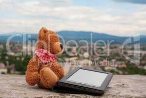 Electronic book reader laying outdoors