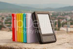 Row of colorful books with electronic book reader