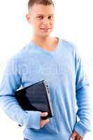 smiling young man holding laptop