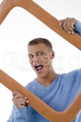 young man posing with frame