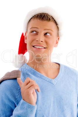 smiling young man with christmas hat looking upside