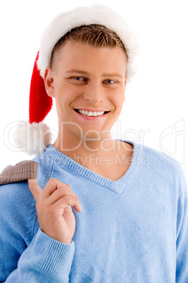 smiling young man with christmas hat looking at camera