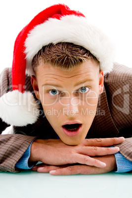 young guy with christmas hat looking at camera