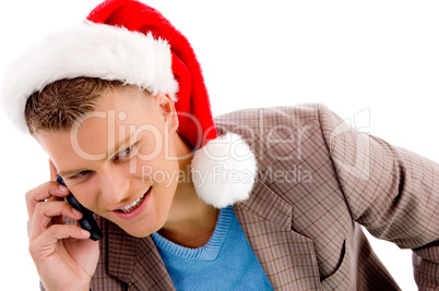 handsome man with christmas hat talking on mobile