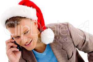 handsome man with christmas hat talking on mobile