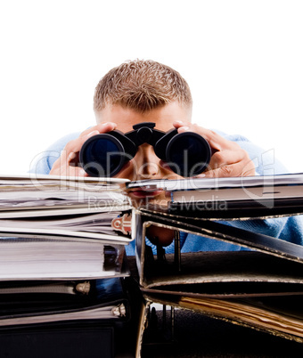 young professional in office looking through binocular