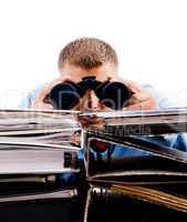young professional in office looking through binocular