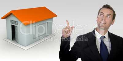 business man gesturing with hand and three dimensional house