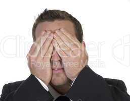 businessman hiding his face in shame