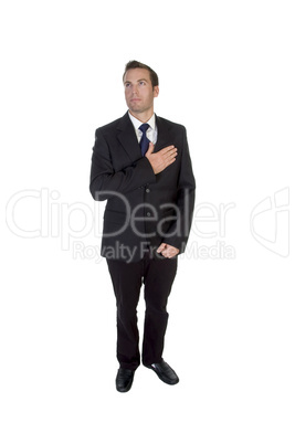 standing businessman saluting by heart