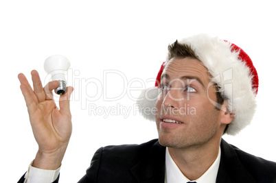 businessman holding bulb and wearing santacap