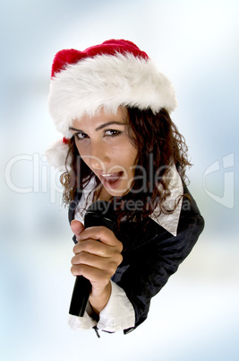 lady wearing christmas hat and singing into microphone