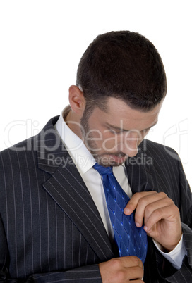 man looking his tie