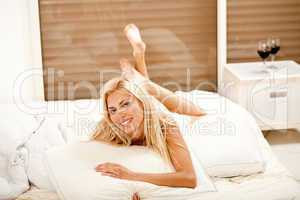 Pretty woman in bed, smiling