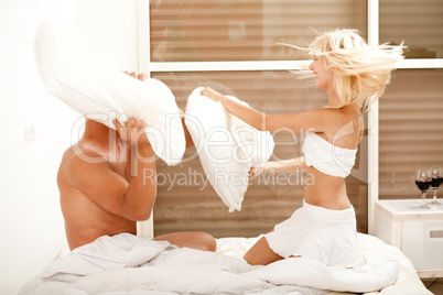 Pillow fight in bedroom