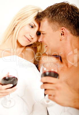 Mid adult couple in bed smiling