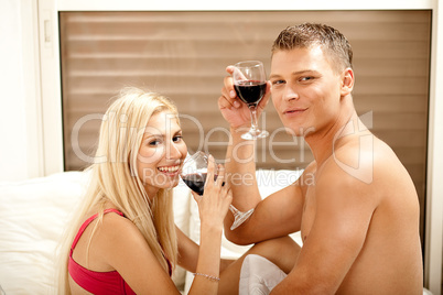 Couple drinking on the bed