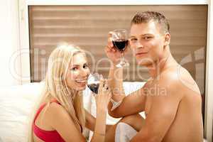 Couple drinking on the bed