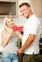 Couple in kitchen with coffee