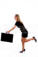 side view of young woman running with briefcase