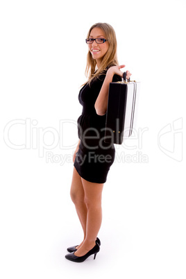 side pose of woman carrying briefcase
