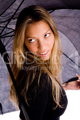 portrait of smiling woman carrying umbrella