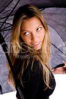 portrait of smiling woman carrying umbrella