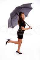 side view of sexy woman carrying umbrella