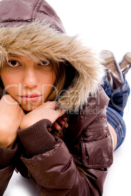 front view of laying young woman with woolen coat