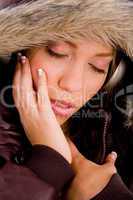close up of adult woman with woolen coat enjoying music